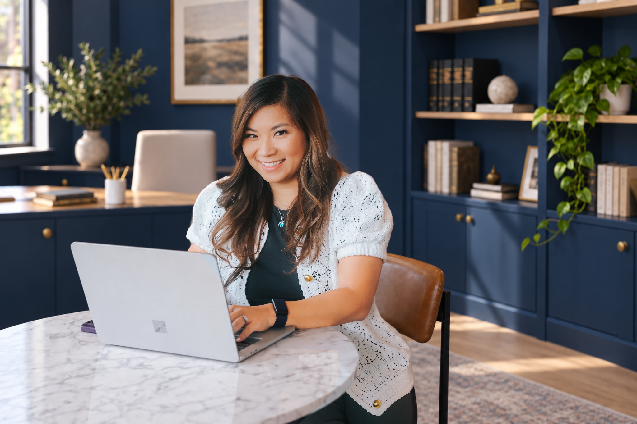 Natalie Nguyen working at her laptop in an office