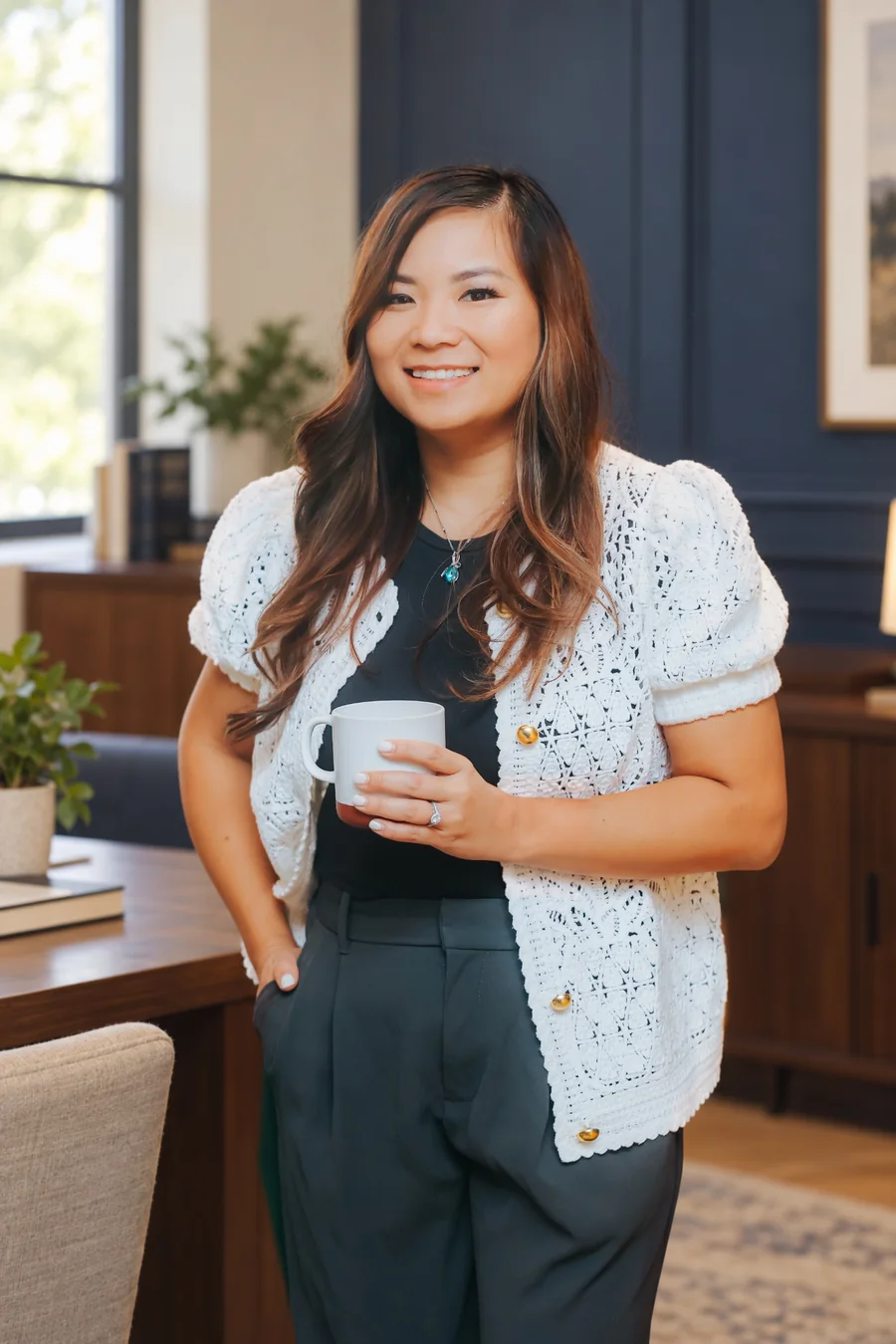 Natalie Nguyen smiling with a coffee cup